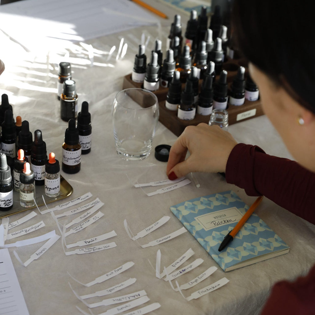 women with many scent strips to make her own perfume