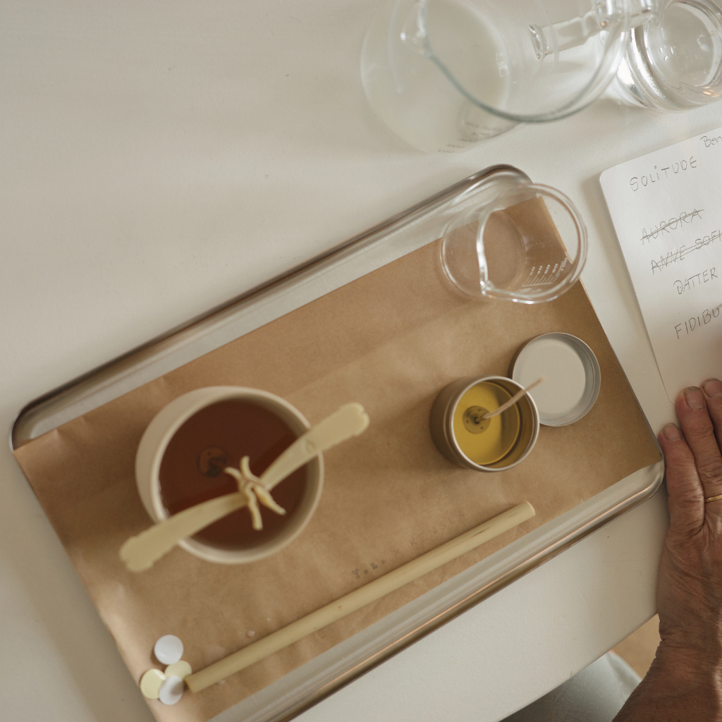Overview of candle making materials and a freshly poured candle during Kensla Studio’s scent workshop